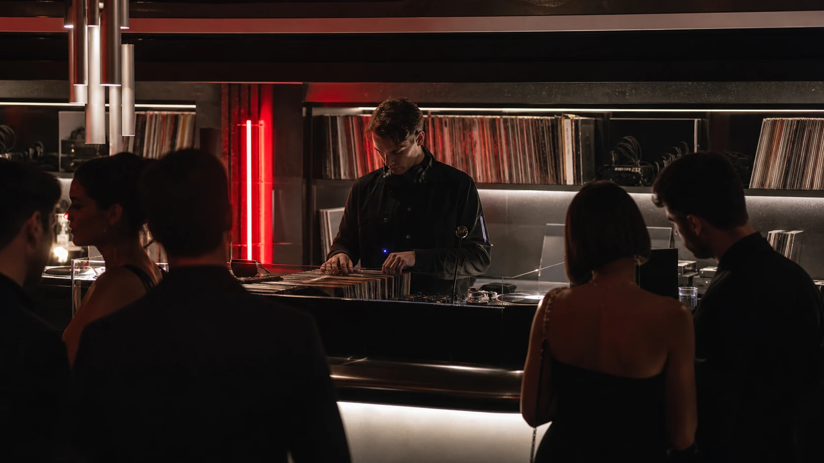 A vinyl selector performing in front of guests at SIDE B